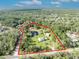 Beautiful aerial view of property with mature trees, pond, outbuildings, and a charming single-Gathering home at 42141 Chinaberry St, Eustis, FL 32736