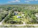 Drone view of property with pond, land, home, and trees on a clear day at 42141 Chinaberry St, Eustis, FL 32736