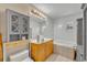 Bathroom featuring a built-in cabinet and a sunken bathtub with tile surround at 42141 Chinaberry St, Eustis, FL 32736