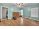 Bright bedroom with hardwood floors, two windows, and an attached bathroom at 42141 Chinaberry St, Eustis, FL 32736