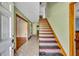 Foyer featuring a staircase, tile flooring, and entryways into adjacent rooms at 42141 Chinaberry St, Eustis, FL 32736