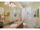 Bathroom featuring granite countertops, a large mirror and a tub with shower at 5029 Greenbriar Trl, Mount Dora, FL 32757