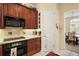 Kitchen featuring dark wood cabinetry, stainless steel appliances, and breakfast nook at 5029 Greenbriar Trl, Mount Dora, FL 32757