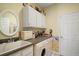 Laundry room with white cabinets, utility sink, and washer and dryer at 5029 Greenbriar Trl, Mount Dora, FL 32757