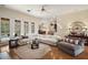 Open-concept living room featuring hardwood floors, a ceiling fan, and large windows at 5029 Greenbriar Trl, Mount Dora, FL 32757