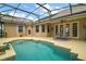 Enjoy the backyard pool, surrounded by a screened enclosure and comfortable seating area at 5029 Greenbriar Trl, Mount Dora, FL 32757