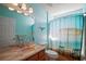 Bathroom features a decorative vanity and a shower with beach-themed curtain at 509 Grand Vista Trl, Leesburg, FL 34748