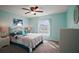 This is a primary bedroom with an airy, light-filled space and decorative ceiling fan at 509 Grand Vista Trl, Leesburg, FL 34748