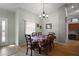 Bright dining room features wood floors, modern chandelier, and doorway to kitchen area at 509 Grand Vista Trl, Leesburg, FL 34748