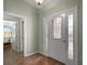 Bright foyer featuring a glass-accented front door, tile flooring, and neutral paint at 509 Grand Vista Trl, Leesburg, FL 34748