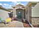 Inviting front entrance with a beautifully designed door and stone detailing with comfortable seating at 509 Grand Vista Trl, Leesburg, FL 34748