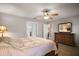 Spacious main bedroom with ceiling fan and dresser, and view into other areas of home at 509 Grand Vista Trl, Leesburg, FL 34748