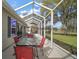 Covered patio with outdoor seating, perfect for entertaining, and view of the lawn at 509 Grand Vista Trl, Leesburg, FL 34748