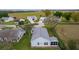 Aerial view of light blue home with a large gray roof and a well maintained backyard at 509 Ventura Ct, The Villages, FL 32159