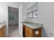 Bright bathroom with wooden cabinets and a view into the bedroom with natural light at 509 Ventura Ct, The Villages, FL 32159