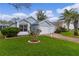 Charming light blue home with well-maintained lawn, two car garage, and manicured landscaping at 509 Ventura Ct, The Villages, FL 32159