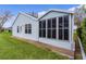 The rear exterior of a light blue home with a screened lanai and manicured landscaping at 509 Ventura Ct, The Villages, FL 32159