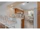 Kitchen view of a breakfast bar and an adjacent seating area at 509 Ventura Ct, The Villages, FL 32159