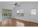 Living room featuring wood floors, sliding doors, and a ceiling fan at 509 Ventura Ct, The Villages, FL 32159