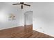 Living room with wood floors, white walls, and an arched doorway at 509 Ventura Ct, The Villages, FL 32159