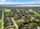 Aerial view of a neighborhood, showing lush landscaping and the surrounding area, pinpointing the property location at 5144 Grove Mnr, Lady Lake, FL 32159