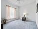 Bright bedroom features neutral carpet, a ceiling fan, and natural light enhancing the living space at 5144 Grove Mnr, Lady Lake, FL 32159