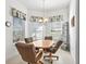 Bright breakfast nook featuring a round table with seating for four and natural light from large windows at 5144 Grove Mnr, Lady Lake, FL 32159