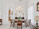 Elegant dining room with wood table, chandelier, and sideboard for a classic look at 5144 Grove Mnr, Lady Lake, FL 32159