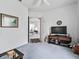 Spacious living room featuring neutral carpet, a ceiling fan, and an entertainment center at 5144 Grove Mnr, Lady Lake, FL 32159