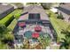 Aerial view of the screened in pool with umbrellas and outdoor seating at 5262 Royce Dr, Mount Dora, FL 32757