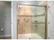 Tiled shower with clear glass doors, grab bars, and multiple shower heads in bright bathroom at 5262 Royce Dr, Mount Dora, FL 32757