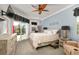 Light and airy bedroom featuring a ceiling fan, TV, and sliding door to a pool and patio at 5262 Royce Dr, Mount Dora, FL 32757