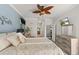 Comfortable bedroom with soft patterned textiles, a mounted TV, and an ensuite door at 5262 Royce Dr, Mount Dora, FL 32757