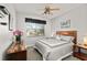 Neat bedroom with gray linens, a window, a modern fan, and warm, natural lighting at 5262 Royce Dr, Mount Dora, FL 32757