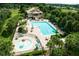 Aerial view of community pool area with sun loungers, tables, and chairs at 5262 Royce Dr, Mount Dora, FL 32757