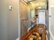 Hallway with a wooden sliding barn door, wood floors, neutral paint, and stylish decor at 5262 Royce Dr, Mount Dora, FL 32757