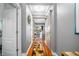 Hallway with a wooden sliding barn door, wood floors, and neutral paint, leading to the living area at 5262 Royce Dr, Mount Dora, FL 32757