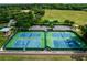 Aerial view of community tennis courts with parking and green space at 5262 Royce Dr, Mount Dora, FL 32757