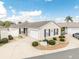 Aerial view of a home with a garage, manicured landscaping and driveway at 527 Richburg St, The Villages, FL 32162