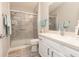 Well-lit bathroom with a glass-enclosed shower, updated vanity, white cabinetry and ample storage space at 527 Richburg St, The Villages, FL 32162