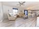 Inviting living room featuring hardwood floors, comfortable seating, and plenty of natural light at 527 Richburg St, The Villages, FL 32162