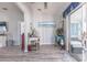 Living room featuring wood-look floors, neutral walls, a desk, and view of the sunroom at 527 Richburg St, The Villages, FL 32162