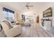 Inviting living room featuring hardwood floors, comfortable seating, and plenty of natural light at 527 Richburg St, The Villages, FL 32162