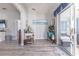 Living room featuring wood-look floors, neutral walls, a desk, and view of the sunroom at 527 Richburg St, The Villages, FL 32162