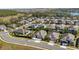 Wide aerial view of neighborhood, showing a lake and community area at 569 Bellflower Way, Clermont, FL 34715