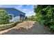 View of backyard with manicured hedges and the back of the home at 569 Bellflower Way, Clermont, FL 34715