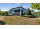 Backyard with manicured hedges surrounding the rear side of the home at 569 Bellflower Way, Clermont, FL 34715