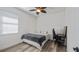 Bright bedroom with a ceiling fan, wood-look floors, and a dedicated workspace at 569 Bellflower Way, Clermont, FL 34715