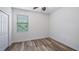 Empty bedroom featuring wood-look floors, a window and a closet at 569 Bellflower Way, Clermont, FL 34715