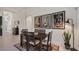 Dining room with a dark wood table, seating for six, and artwork at 569 Bellflower Way, Clermont, FL 34715